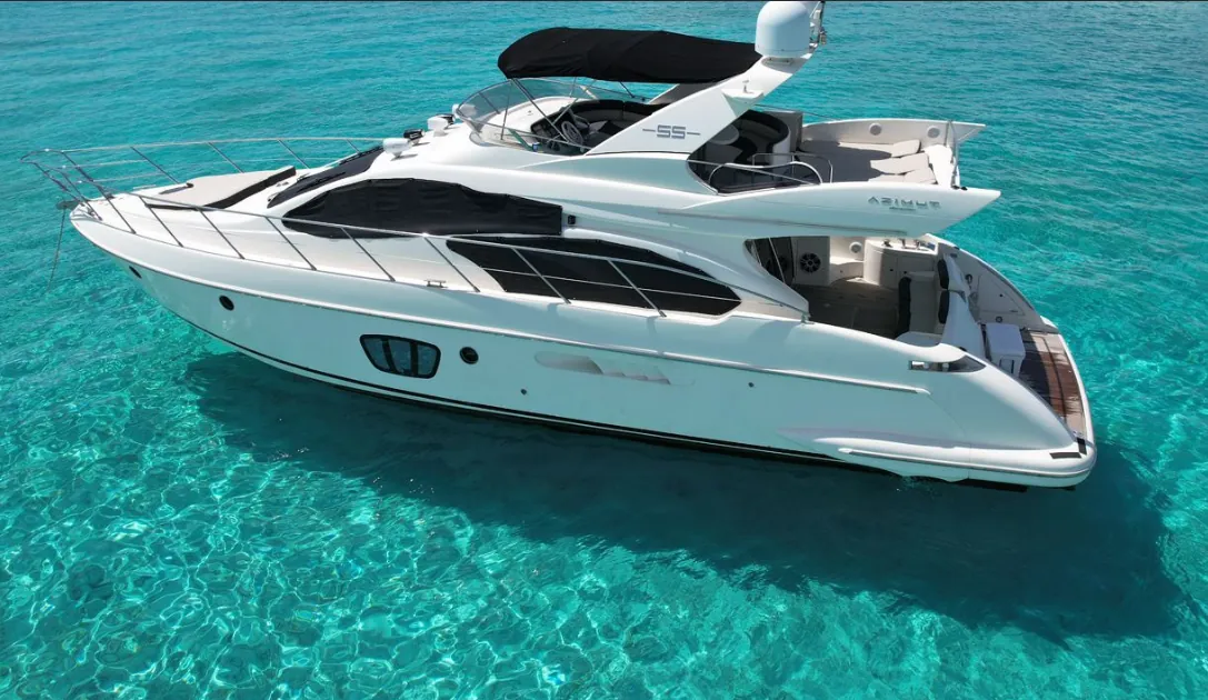 White Azimut yacht anchored in turquoise water, seen from above