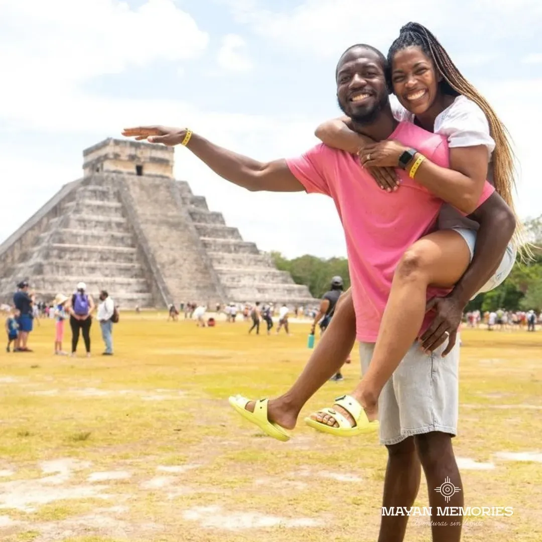 Man giving a woman a piggyback ride in front of the pyramid
