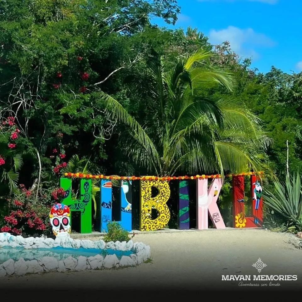 Colorful Hubiku letters among the plants