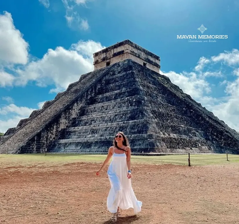 Woman in a white dress in front of the Kukulkán pyramid at Chichén Itzá