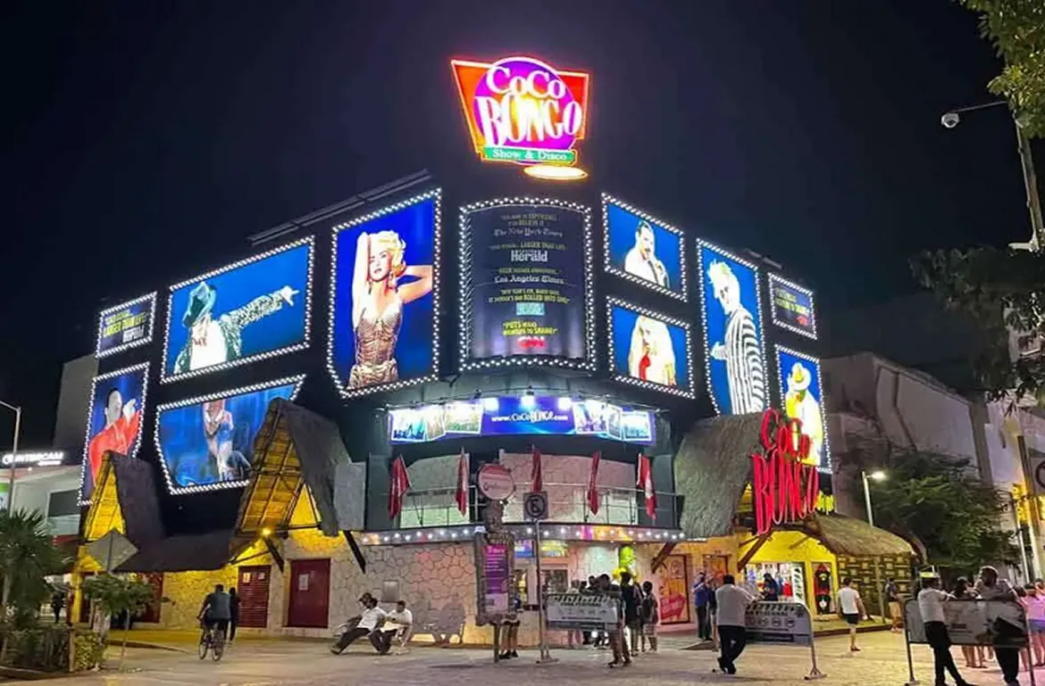 Lit facade of Coco Bongo Playa del Carmen at night