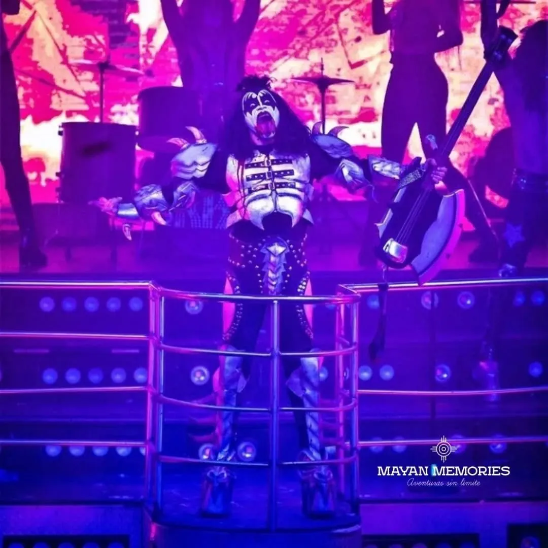 Performer in rock costume under purple lights on stage