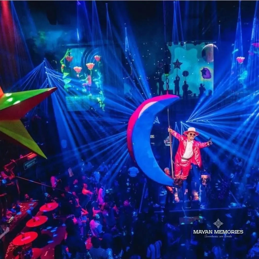 Acrobat on a crescent moon among blue lights and lasers