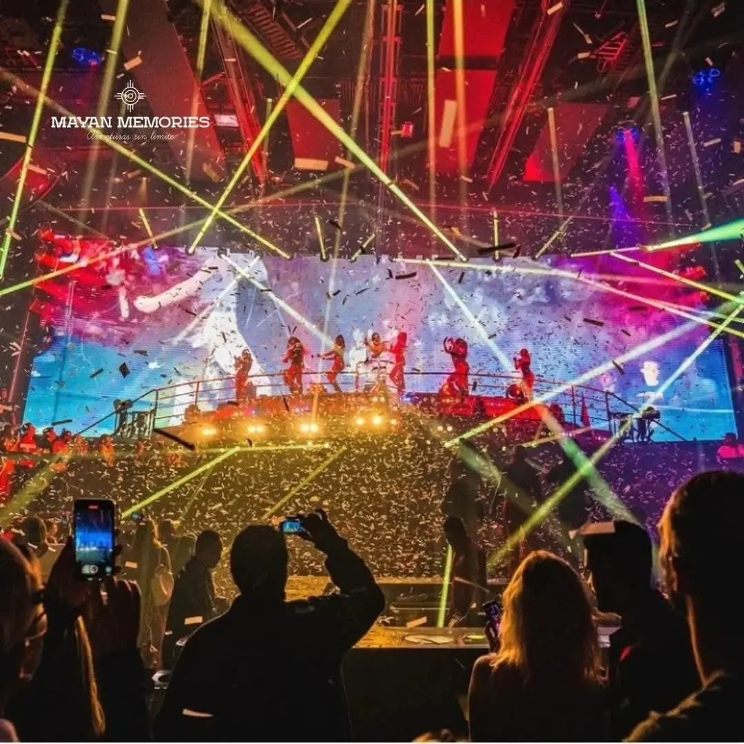 Crowd with phones in front of a stage full of lasers