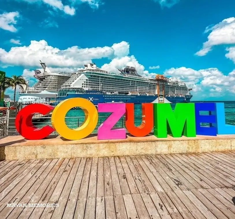 Colorful Cozumel letters on the pier with a cruise ship behind