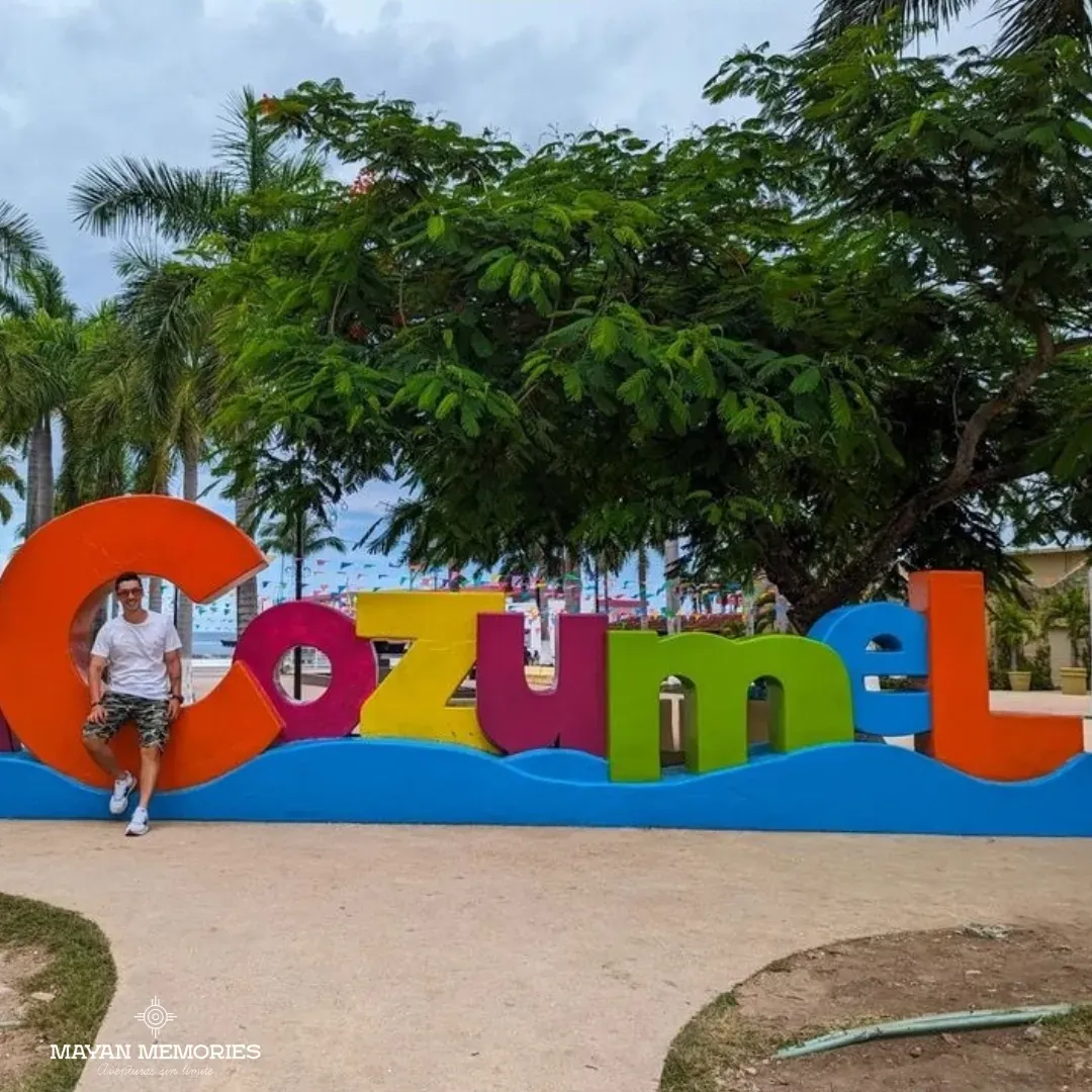 Woman posing in front of the colorful Cozumel letters