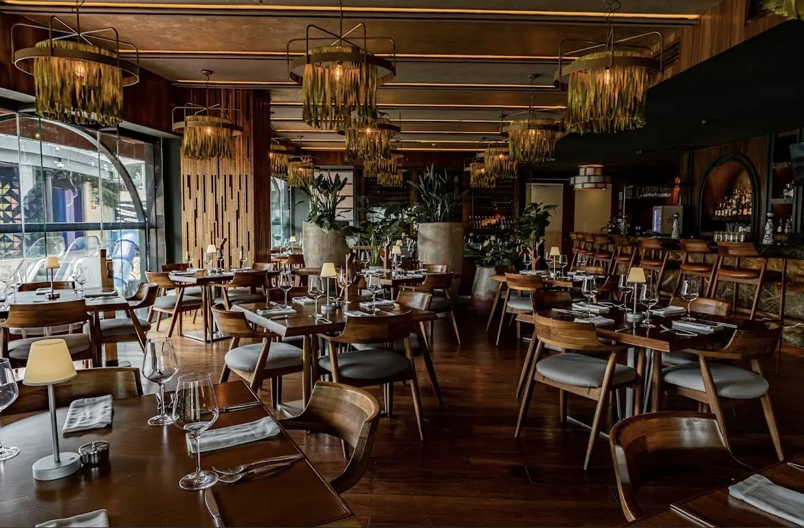 Harry's dining room with wood, lamps and set tables