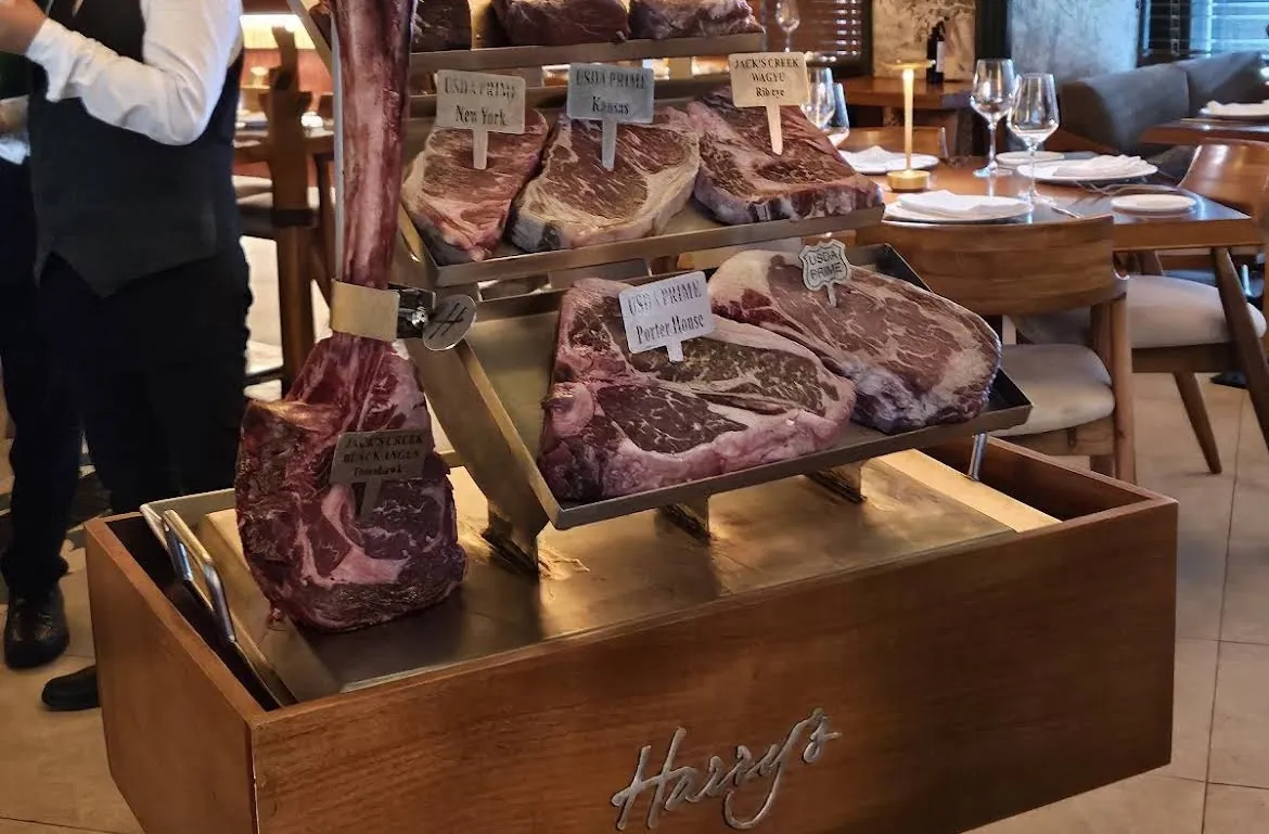 Raw cuts of beef presented on a wooden tray