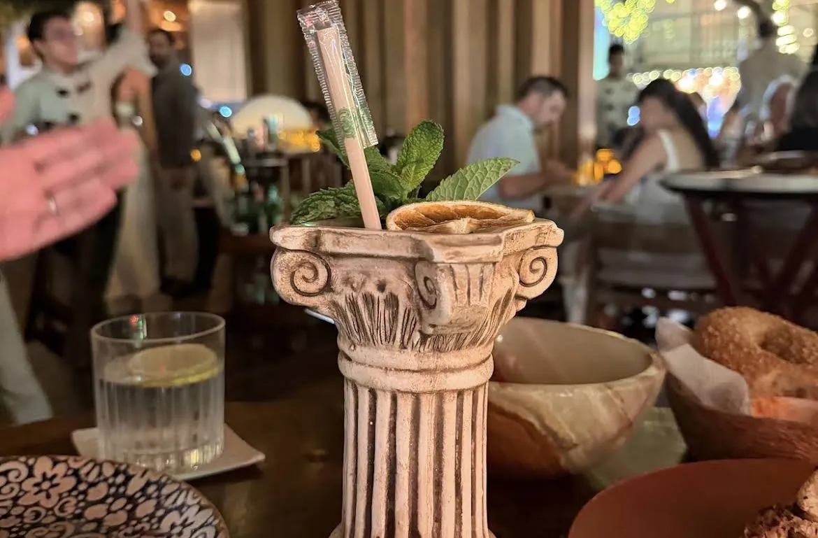 Cocktail served in a glass with a Greek column base
