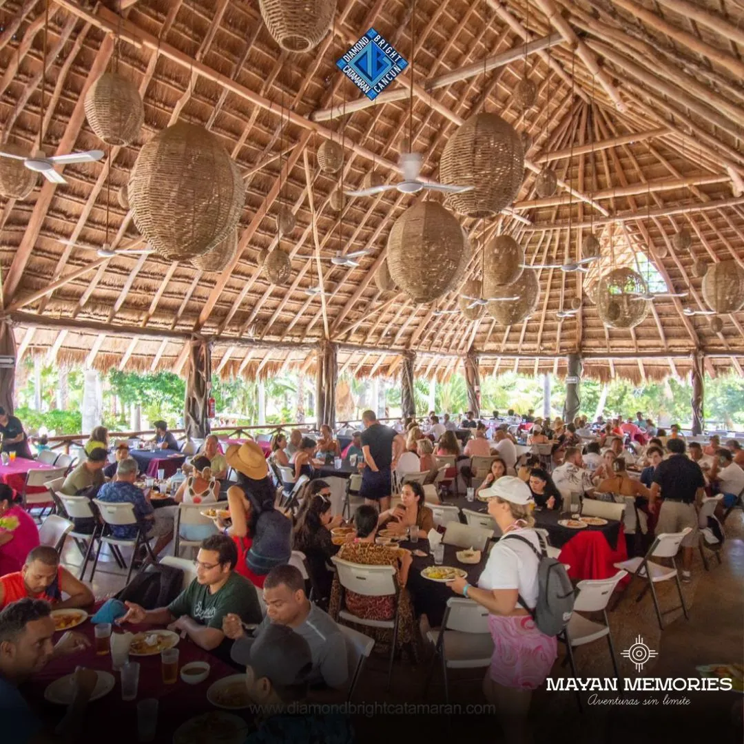 Busy restaurant under a large palapa on Isla Mujeres