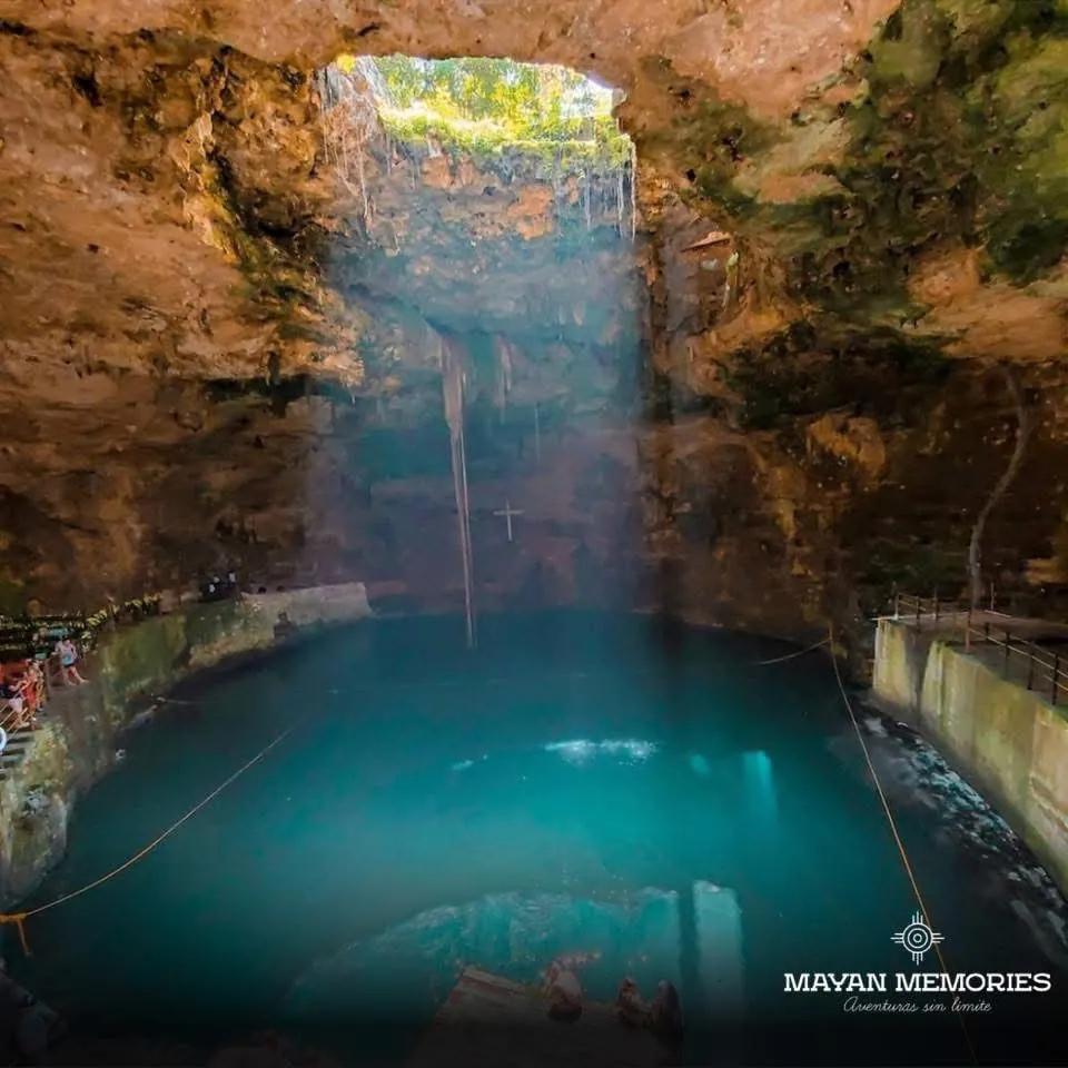 Hubiku cenote with a beam of light on the water