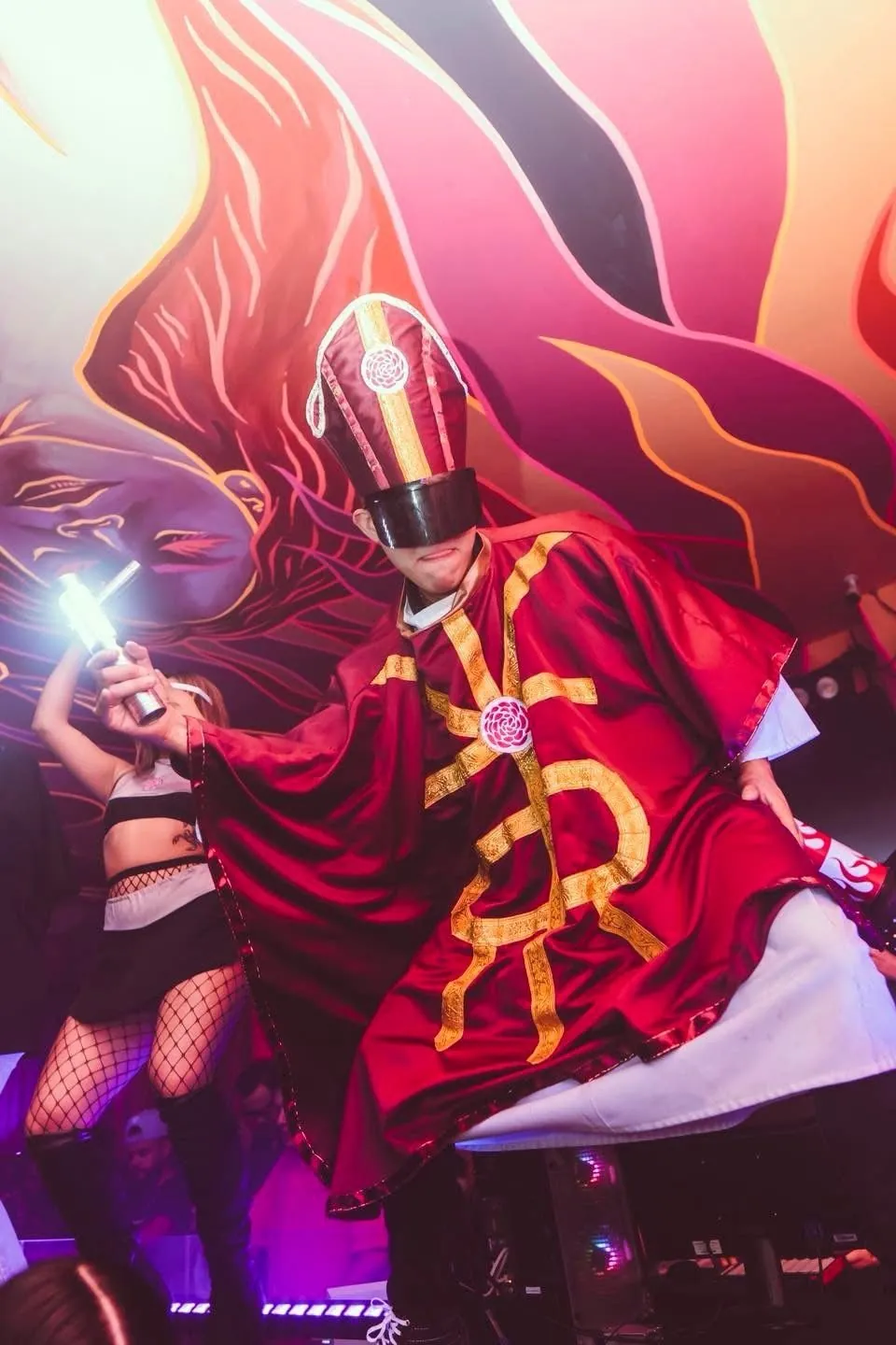 Host in a red costume with lights at the party
