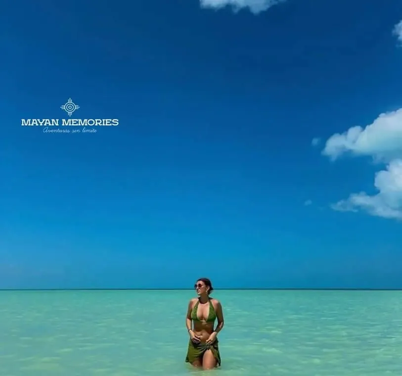 Person in the shallow turquoise water of Holbox