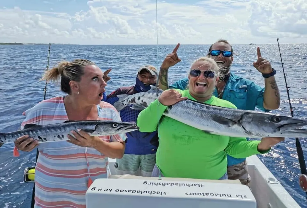 Group of anglers showing their catch on the boat
