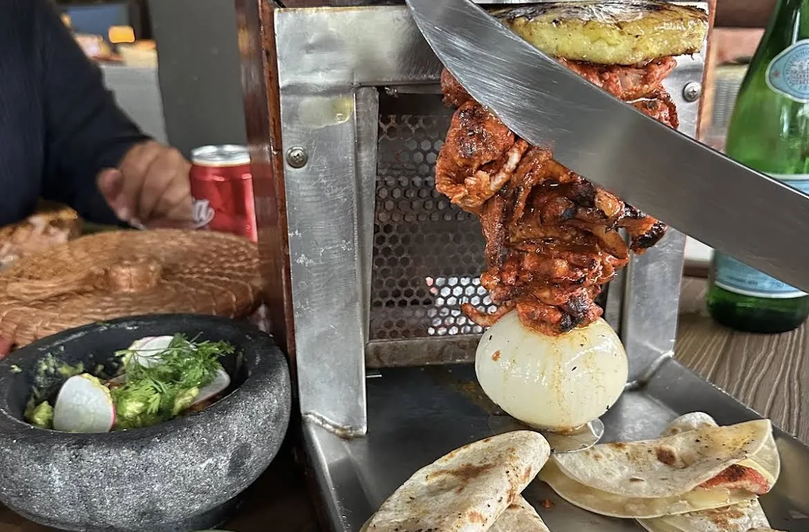 Al pastor taco spit served at the table with a molcajete
