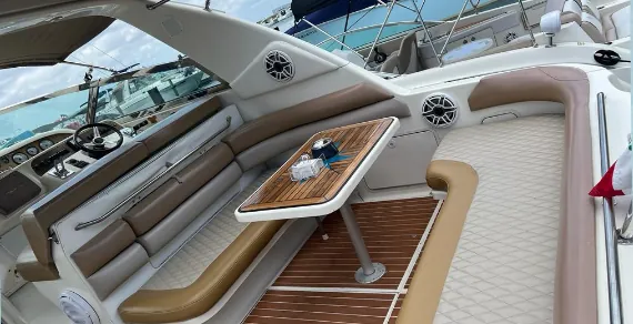 Yacht's aft deck with white seating and teak floor