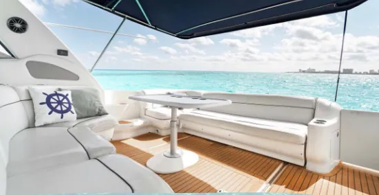 Yacht's aft deck with white seating and sea view