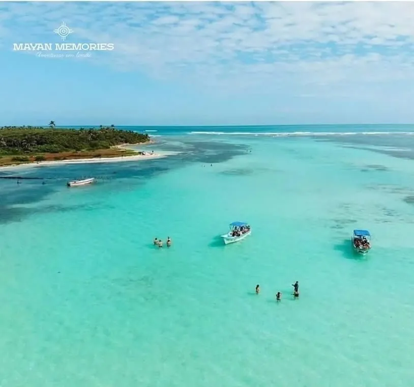 Aerial view of boats in shallow turquoise water