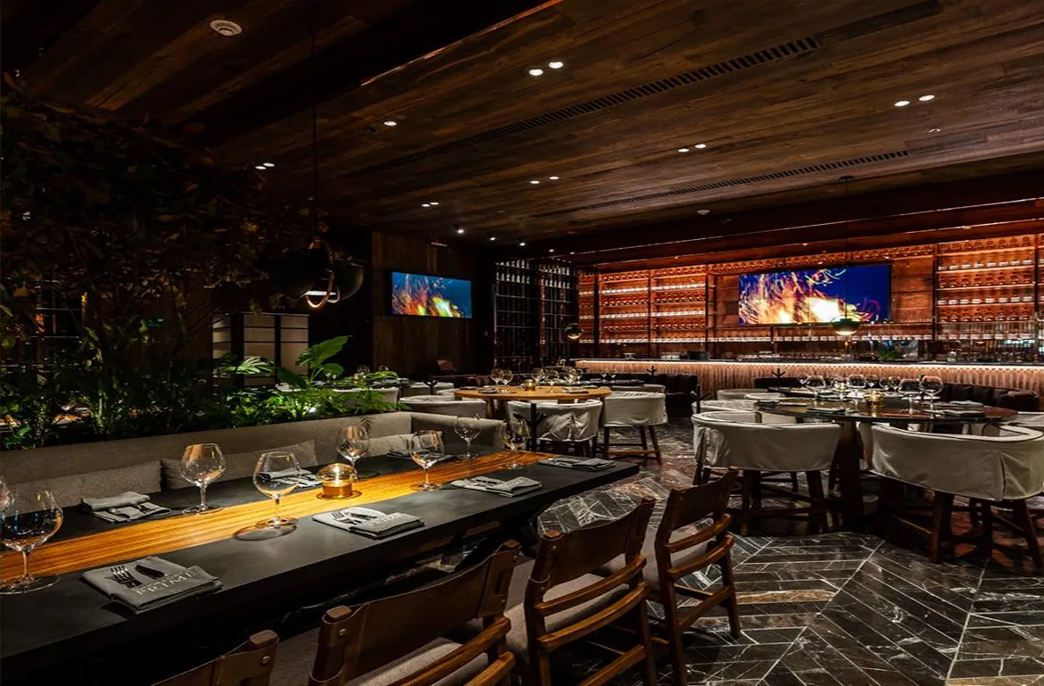 Sonora Prime dining room with dark wood and set tables