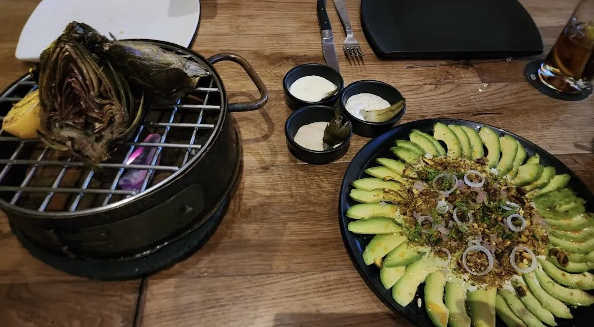 Meat on a tabletop grill with sides