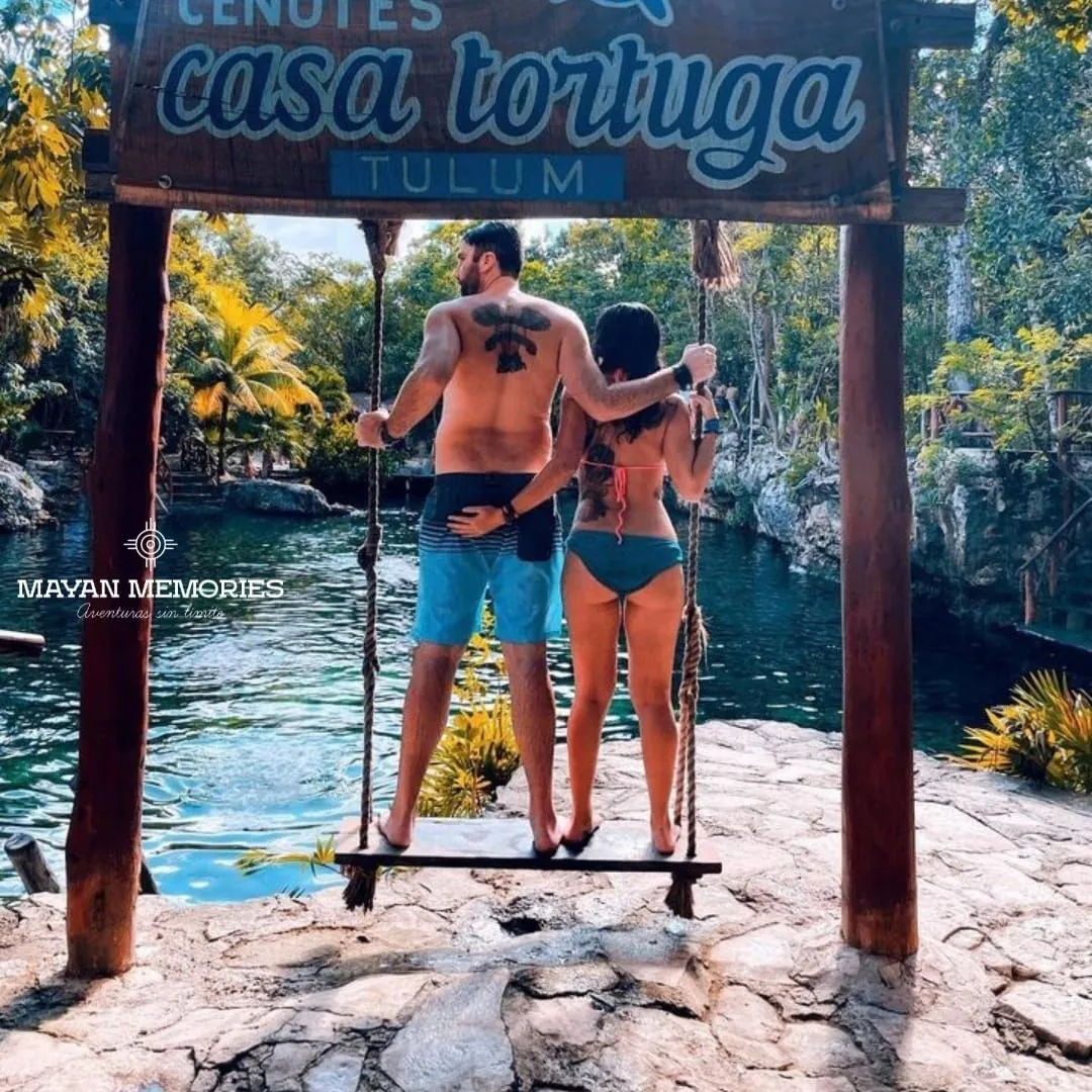 Couple on a wooden swing over a cenote