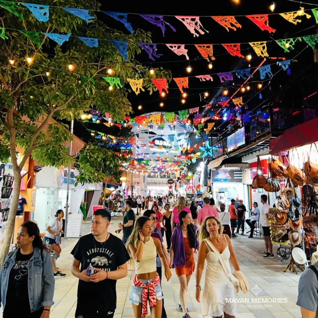 Fifth Avenue in Playa del Carmen with papel picado and passersby