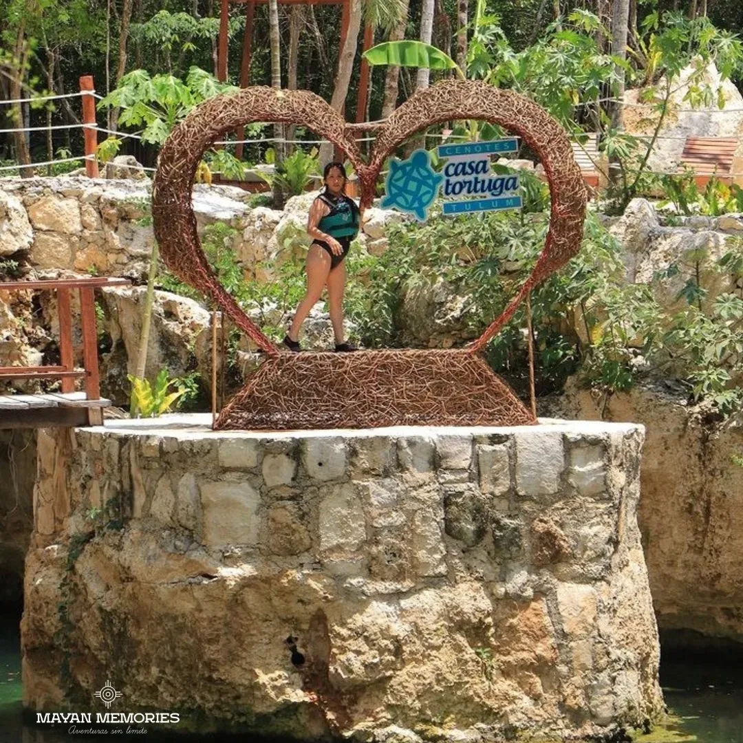 Woman posing inside a heart-shaped wooden frame