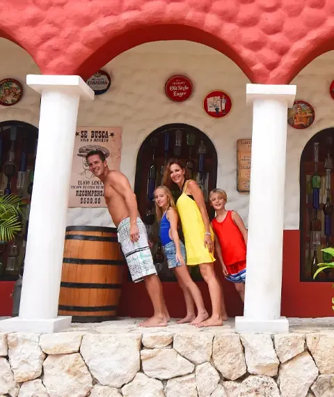 Family posing in an optical illusion scene at Xenses