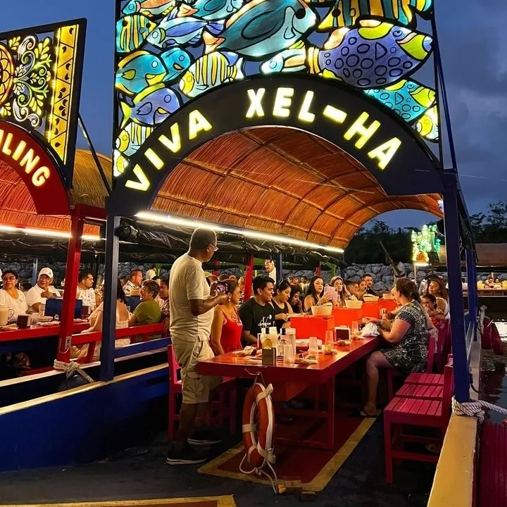 Guests having dinner on board a lit trajinera
